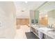 Bright locker room features tiled floors, plenty of storage lockers, and a granite countertop with dual sinks and mirrors at 7167 E Rancho Vista Dr # 4011, Scottsdale, AZ 85251