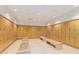 Spacious locker room with tiled floors, wood benches and rows of wood storage lockers at 7167 E Rancho Vista Dr # 4011, Scottsdale, AZ 85251