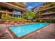 A refreshing outdoor swimming pool with a tiled border, set amidst landscaped greenery at 7167 E Rancho Vista Dr # 4011, Scottsdale, AZ 85251