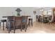 Entertainer's bar adjacent to a dining area with tile floors, neutral decor, and wood accents at 7611 E Pasadena Ave, Scottsdale, AZ 85250
