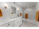 Bright bathroom featuring white vanity, tub-shower combination, and neutral tile flooring at 7611 E Pasadena Ave, Scottsdale, AZ 85250