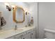 Bright bathroom with classic vanity, decorative mirror, and coordinated fixtures at 7611 E Pasadena Ave, Scottsdale, AZ 85250
