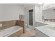 Bright bathroom featuring a tiled bathtub and shower at 7611 E Pasadena Ave, Scottsdale, AZ 85250