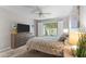 Comfortable bedroom with neutral tones, ceiling fan, and sliding glass door offering outdoor views at 7611 E Pasadena Ave, Scottsdale, AZ 85250