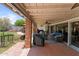 Spacious covered patio with comfortable seating and outdoor kitchen area, perfect for relaxing and entertaining guests at 7611 E Pasadena Ave, Scottsdale, AZ 85250