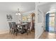 Dining room with a dining table, neutral color scheme, and an adjacent doorway at 7611 E Pasadena Ave, Scottsdale, AZ 85250