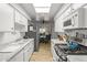 Bright kitchen featuring wood-look floors, white cabinets, and stainless appliances at 7611 E Pasadena Ave, Scottsdale, AZ 85250