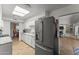 Bright kitchen featuring stainless steel appliances, wood floors, and ample cabinet space at 7611 E Pasadena Ave, Scottsdale, AZ 85250
