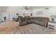 Spacious living room with tile flooring, a ceiling fan, and a large sofa at 7611 E Pasadena Ave, Scottsdale, AZ 85250