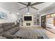 Comfortable living room featuring a brick fireplace with built-ins and backyard patio access at 7611 E Pasadena Ave, Scottsdale, AZ 85250