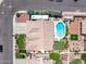 An aerial view of a backyard featuring a pool, patio, lush landscaping, and an RV parked in the driveway at 7648 W Mauna Loa Ln, Peoria, AZ 85381