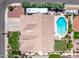 Overhead view of a home with a three-car garage, pool, patio, and lush landscaping at 7648 W Mauna Loa Ln, Peoria, AZ 85381