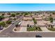 Neighborhood aerial view showcasing a house with a three-car garage and well-manicured landscaping at 7648 W Mauna Loa Ln, Peoria, AZ 85381
