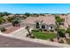 Residential aerial view showcasing a house with a three-car garage and mature landscaping at 7648 W Mauna Loa Ln, Peoria, AZ 85381
