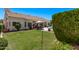 A well-maintained backyard featuring lush green grass and a beautiful patio area at 7648 W Mauna Loa Ln, Peoria, AZ 85381