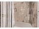 Tile surround in the bathtub shower of this bathroom at 7648 W Mauna Loa Ln, Peoria, AZ 85381