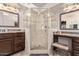 Bathroom featuring a glass-enclosed shower, vanity, updated fixtures and decorative vanity lighting at 7648 W Mauna Loa Ln, Peoria, AZ 85381
