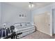 Light bedroom with coastal-themed decor and exercise bike at 7648 W Mauna Loa Ln, Peoria, AZ 85381