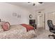 Spacious bedroom includes desk area and wall-mounted television at 7648 W Mauna Loa Ln, Peoria, AZ 85381
