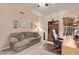 Bright bedroom with comfortable sitting area and ceiling fan at 7648 W Mauna Loa Ln, Peoria, AZ 85381