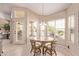 Charming breakfast nook with bright windows and casual dining setup, perfect for morning gatherings at 7648 W Mauna Loa Ln, Peoria, AZ 85381