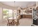 Bright breakfast nook adjacent to the kitchen, featuring casual seating and plenty of natural light at 7648 W Mauna Loa Ln, Peoria, AZ 85381