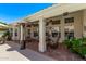 Charming covered patio with comfortable seating, ceiling fans, and a view of the well-maintained backyard at 7648 W Mauna Loa Ln, Peoria, AZ 85381
