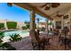 A cozy covered patio features ample seating and offers tranquil views of the sparkling pool at 7648 W Mauna Loa Ln, Peoria, AZ 85381
