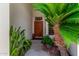 Home entryway with beautiful plants surrounding the front door at 7648 W Mauna Loa Ln, Peoria, AZ 85381