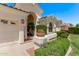 Front entrance of a home with manicured landscaping, including green bushes and desert stones at 7648 W Mauna Loa Ln, Peoria, AZ 85381