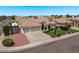 Charming home with a three-car garage, mature landscaping, and well-manicured lawn at 7648 W Mauna Loa Ln, Peoria, AZ 85381