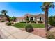 Landscaped front yard view of a home with RV parking and a three-car garage at 7648 W Mauna Loa Ln, Peoria, AZ 85381