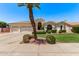 Inviting home featuring lush landscaping, a three-car garage, and a well-maintained lawn at 7648 W Mauna Loa Ln, Peoria, AZ 85381