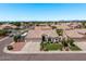 Attractive home showcasing a three-car garage, manicured lawn, and vibrant landscaping at 7648 W Mauna Loa Ln, Peoria, AZ 85381