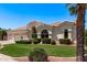 Beautiful home with a well-manicured lawn, vibrant landscaping, and a three-car garage at 7648 W Mauna Loa Ln, Peoria, AZ 85381