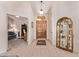 Welcoming foyer featuring tile flooring, display shelving, and an elegant entry door at 7648 W Mauna Loa Ln, Peoria, AZ 85381