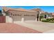 Spacious three-car garage with decorative doors and ample driveway space at 7648 W Mauna Loa Ln, Peoria, AZ 85381