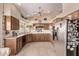 Spacious kitchen featuring wood cabinets, stainless steel appliances, and stone countertops at 7648 W Mauna Loa Ln, Peoria, AZ 85381
