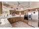 Traditional kitchen with stainless steel appliances, wood cabinets, tile floors and granite countertops at 7648 W Mauna Loa Ln, Peoria, AZ 85381