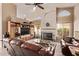 Spacious living area featuring a fireplace, entertainment center, and comfortable leather seating at 7648 W Mauna Loa Ln, Peoria, AZ 85381