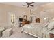 Tranquil main bedroom featuring a ceiling fan and a private entrance to the backyard at 7648 W Mauna Loa Ln, Peoria, AZ 85381