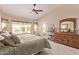 Well-lit main bedroom with a ceiling fan and a private entrance to the backyard at 7648 W Mauna Loa Ln, Peoria, AZ 85381