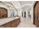 Lavish bathroom featuring dark wood cabinets, travertine counters, and tiled floors, offering elegance and functionality at 8329 N Ridgeview Dr, Paradise Valley, AZ 85253