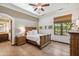 Inviting bedroom with a wooden bed frame, wood floors, natural lighting and a view to the outside at 8329 N Ridgeview Dr, Paradise Valley, AZ 85253