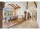 Open dining room showcasing a grand chandelier, hardwood floors, views through an arched window, and access to a hall at 8329 N Ridgeview Dr, Paradise Valley, AZ 85253