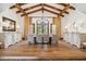 Elegant dining room with a vaulted ceiling, exposed beams, a chandelier, hardwood floors, and two built-in cabinets at 8329 N Ridgeview Dr, Paradise Valley, AZ 85253