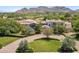 Beautiful exterior of a home featuring a circular driveway, mature trees, and manicured landscaping, enhancing its curb appeal at 8329 N Ridgeview Dr, Paradise Valley, AZ 85253