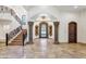 Stately foyer featuring soaring ceilings, stone columns, and a grand staircase creating an impressive entrance at 8329 N Ridgeview Dr, Paradise Valley, AZ 85253