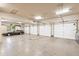 Spacious four-car garage featuring ample storage space, a car, and epoxy flooring at 8329 N Ridgeview Dr, Paradise Valley, AZ 85253