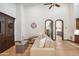 Cozy living room with high ceilings, wood floors, neutral tones, and seamless flow into adjacent rooms at 8329 N Ridgeview Dr, Paradise Valley, AZ 85253